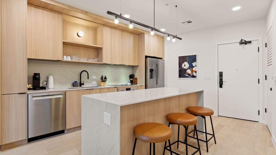 Barstool seating at the kitchen island. (Unit 310)