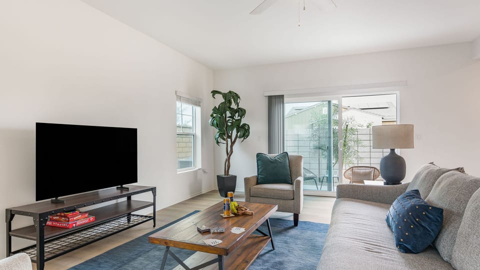 Welcome to your spacious, sun-filled living room featuring sleek wood-style flooring.  (Summerwell 1)