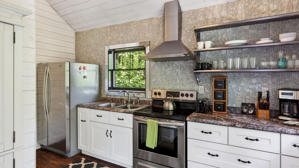 Sleek countertops and a decorative backsplash make meal prep a breeze.