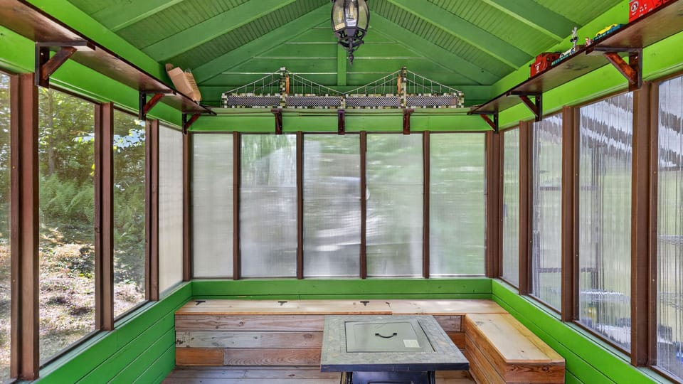 Enjoy the fresh air without the bugs in this vibrant, green-tinted outdoor lounge.