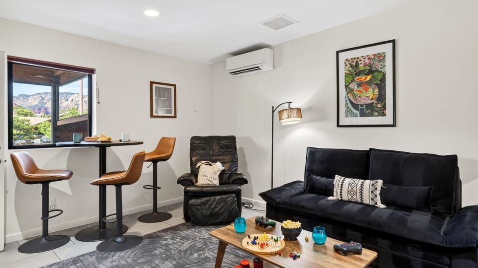 Kick back in the inviting living area featuring a queen sleeper sofa, cozy seating, and a perfect setup for movie nights or game time.