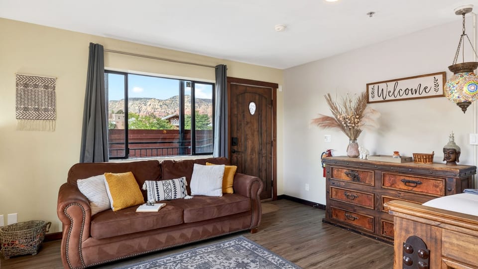 Stretch out in the cozy lounge area featuring a queen sleeper sofa and scenic Sedona red rock views just outside the window.