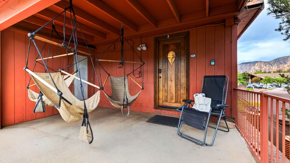 Kick back on the spacious porch with hanging hammock chairs and red rock views—the perfect spot to unwind after a day of adventure. (Canyon Drift)