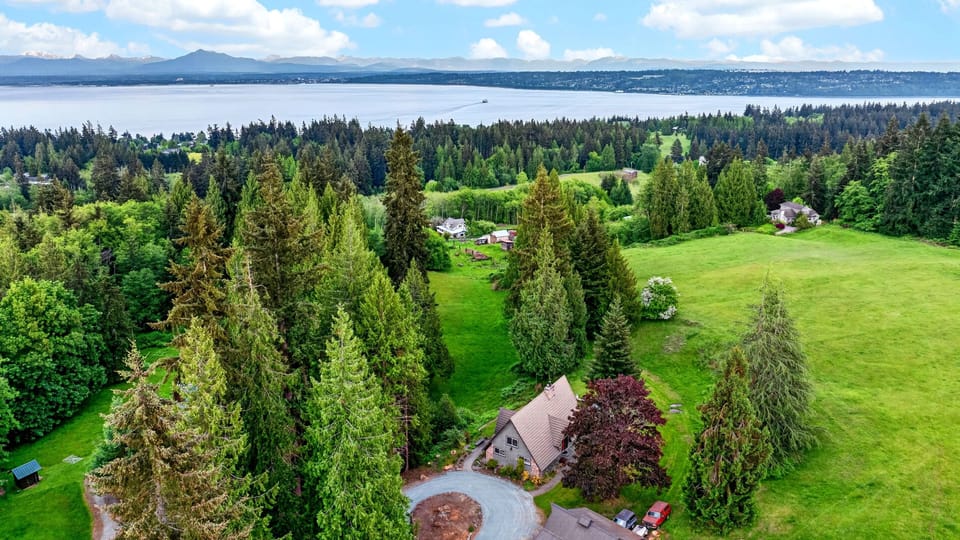 A private Whidbey Island retreat surrounded by evergreens, open lawns, and sweeping water views.