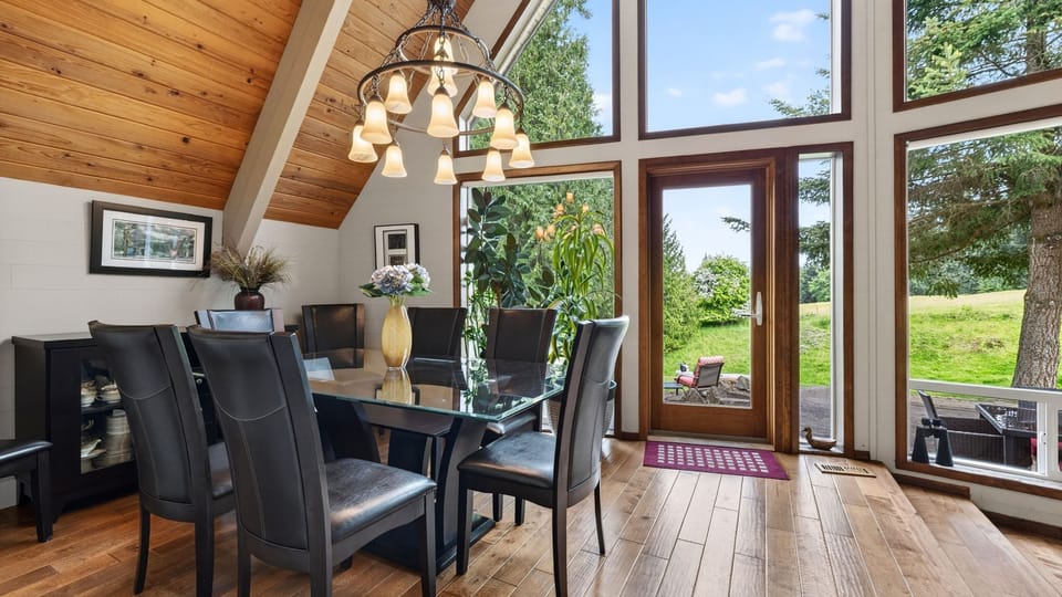 Dine beneath vaulted wood ceilings with floor-to-ceiling windows and peaceful green views all around.