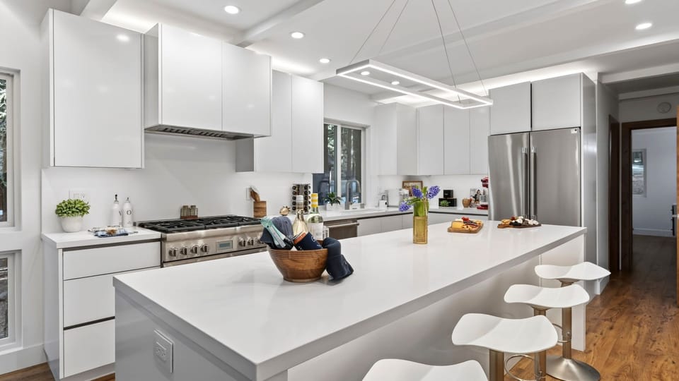 Crisp white quartz countertops offer ample prep space for culinary enthusiasts.