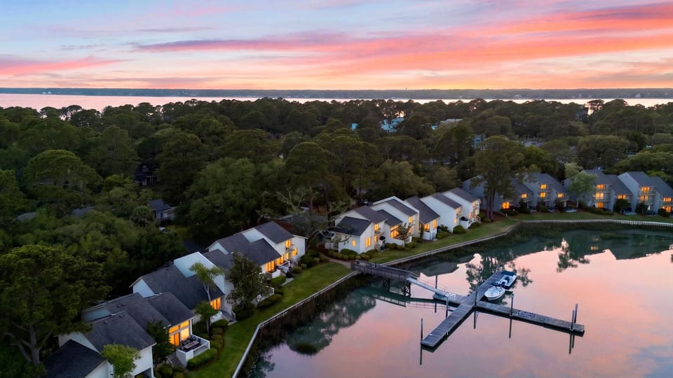 Sunset reflections and dock access create a serene waterfront setting for your coastal escape.