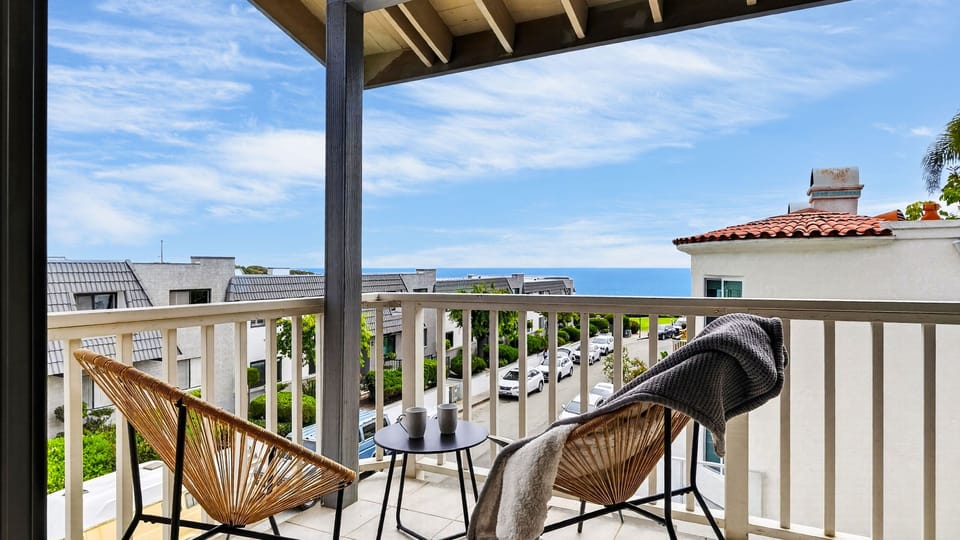 Private balcony setup with ocean views—perfect for morning coffee or sunset drinks by the coast.