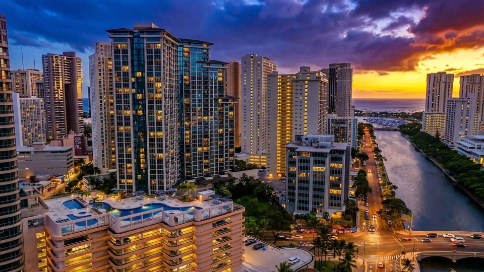 Building exterior. Spectacular twilight view highlighting the vibrant city lights and coastal high-rises.