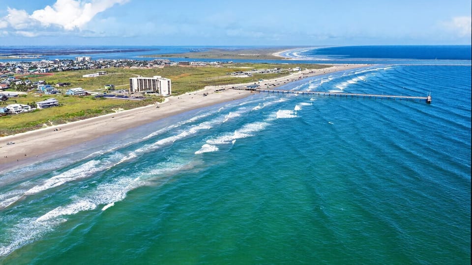 Stunning coastal panorama showing the sweeping beachline and turquoise horizon of your next vacation destination.