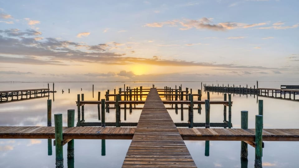 Start the day with sunrise views from the dock overlooking calm bay waters.