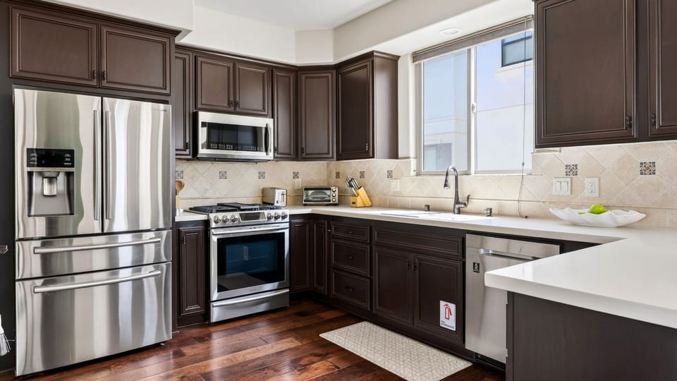Generous counter space, modern fixtures, and deep drawers provide exceptional kitchen storage and functionality.
