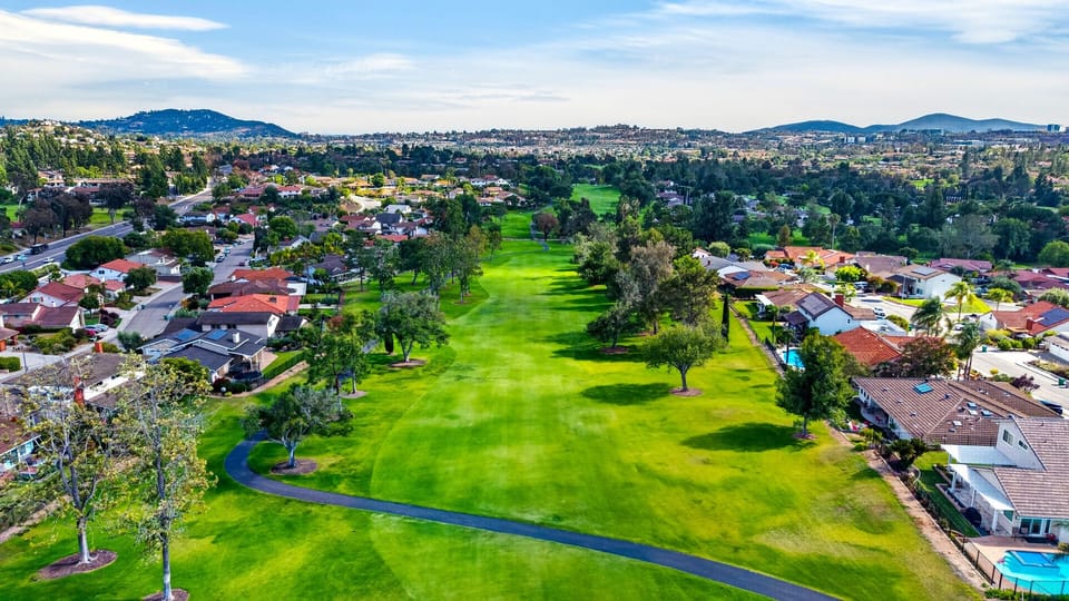 Endless views of vibrant green fairways stretching toward distant mountains—true resort-style living at its absolute finest.