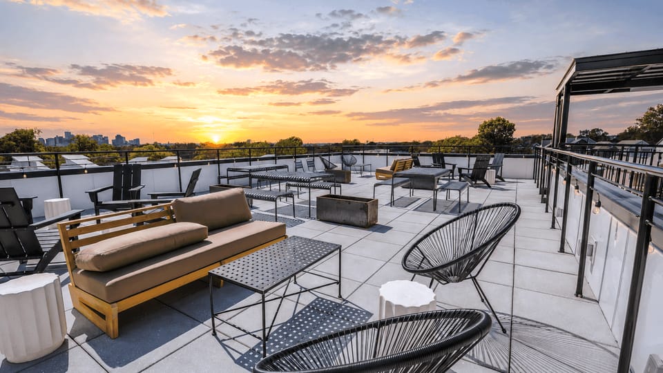 Shared rooftop terrace with multiple seating and tables.