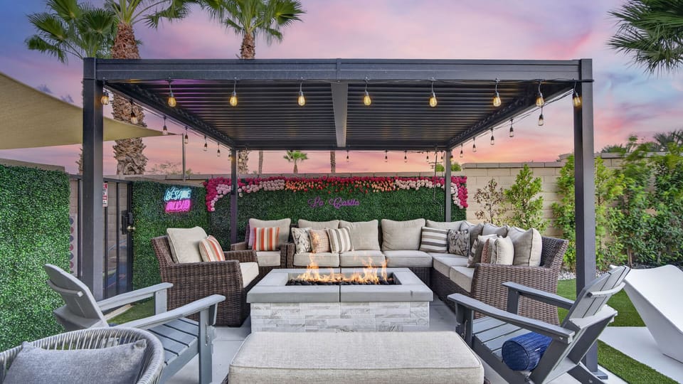 Cozy up by the fire pit lounge at twilight, featuring vibrant neon accent lighting and plush outdoor seating.