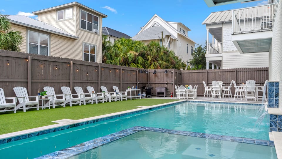 Private backyard oasis featuring a pristine pool and sunbathing area.