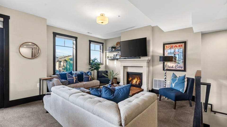 Expansive family room showcasing comfortable sectional seating and a central fireplace.