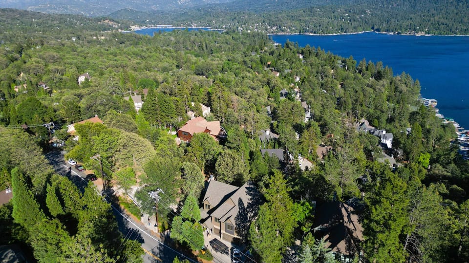 Wide aerial drone perspective of the property and expansive lake line.