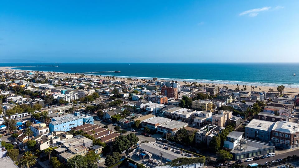 Aerial view of the community with the coastline on the horizon.
