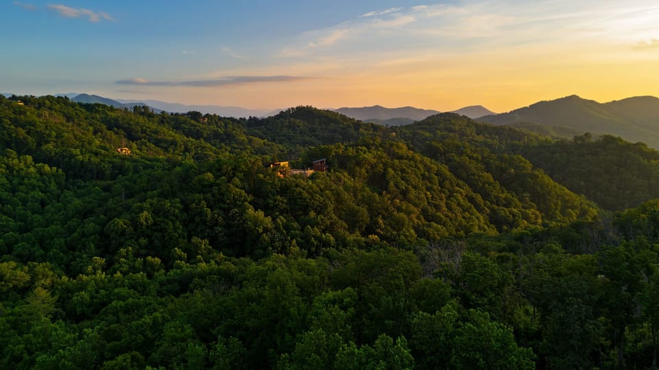 Beautiful sunset landscape view capturing the peaceful layers of the surrounding mountains.