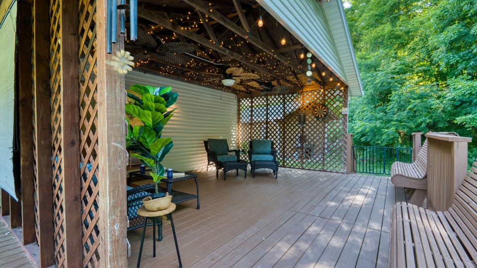 Wrap-around covered deck offering a private, shaded sanctuary surrounded by nature.