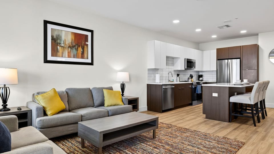 Relax in the comfortable open-concept living area, with a full kitchen and island seating close by.
