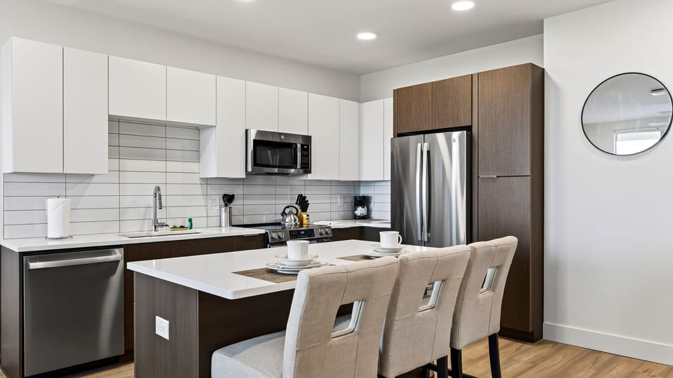 Prepare meals in the fully equipped kitchen, complete with modern appliances and island seating.