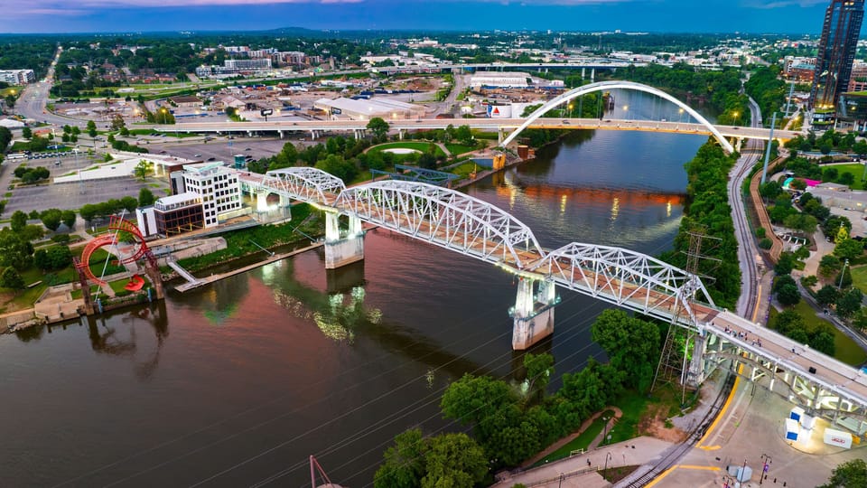 Experience Nashville’s downtown energy, riverfront parks, and iconic skyline beneath a colorful sunset.