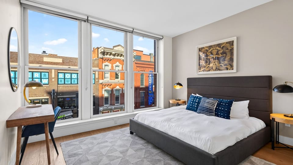 The primary bedroom features a king bed and a desk.