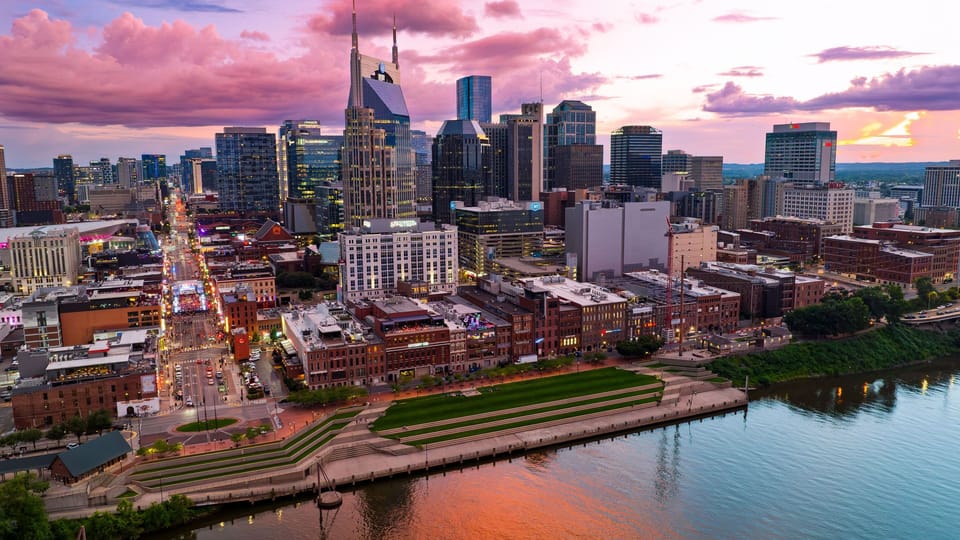 Experience Nashville’s downtown energy, riverfront parks, and iconic skyline beneath a colorful sunset.