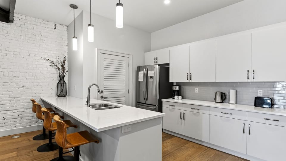 The modern layout keeps everyone in on the conversation, seamlessly connecting the kitchen to the living room.
