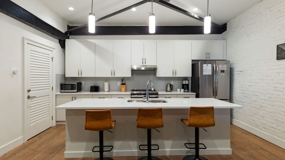The modern layout keeps everyone in on the conversation, seamlessly connecting the kitchen to the living room.