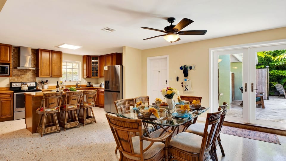 Gather for meals in the open dining area, with island seating and easy access to the patio.