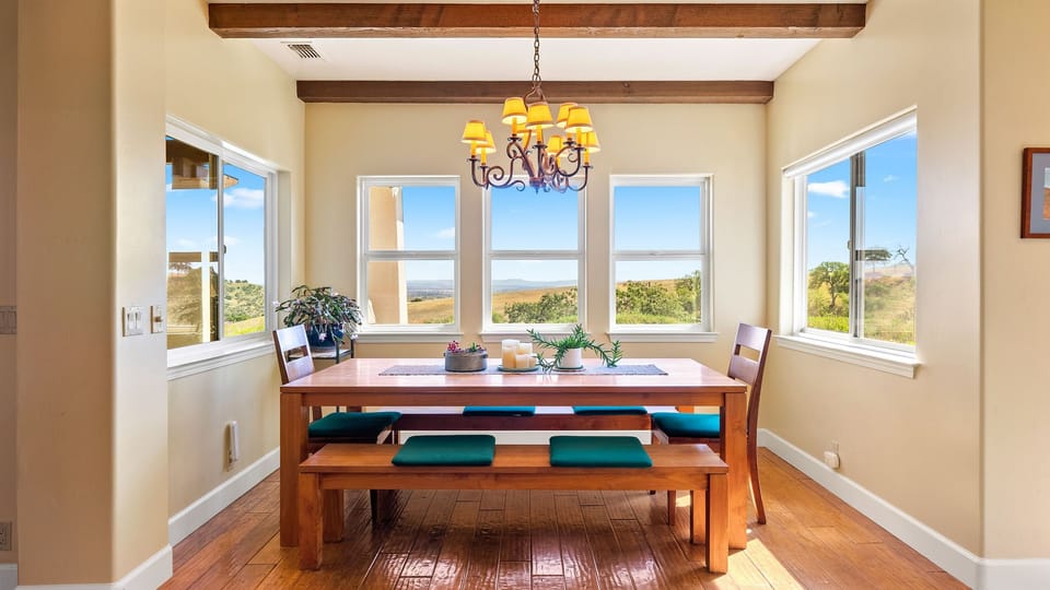Gather around the dining table with wide window views