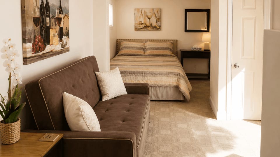 Unwind on the sofa beside a tucked-away bed.