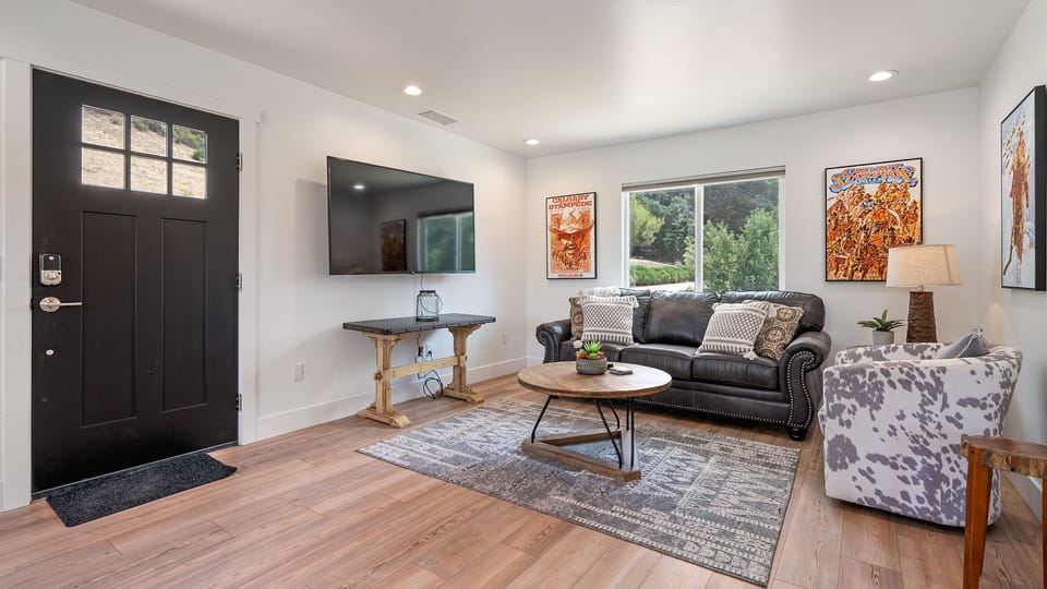 Leather sofa seating and a wall-mounted TV make for easy downtime.