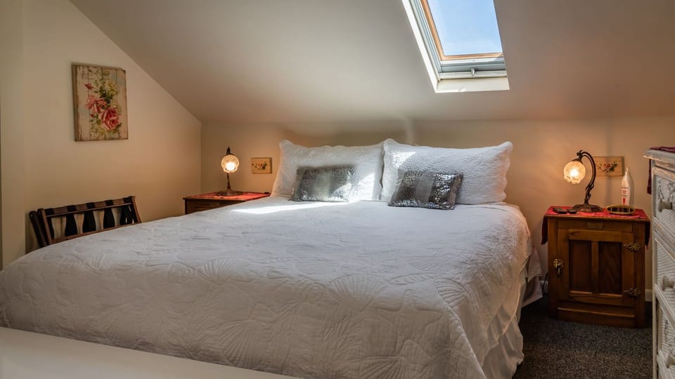 Skylight glow settles over the plush bed