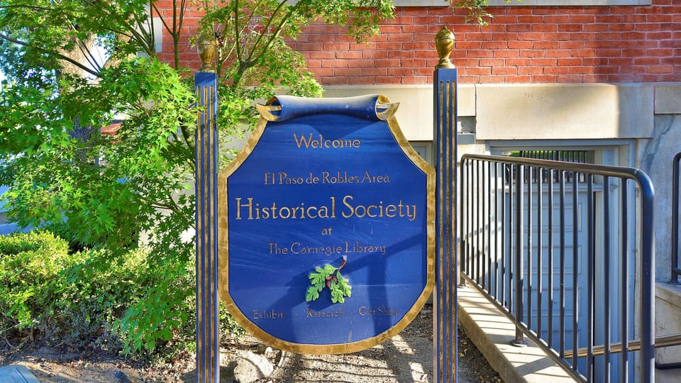 Brick facade and iron railings frame a historic welcome