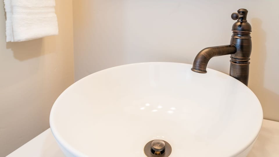 Start the morning at the vessel sink with warm bronze hardware