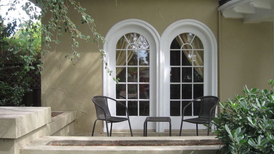 Shaded seating beside the arched doors