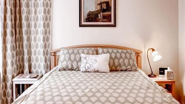 Bedroom 1 offers a king bed, soft natural light, and a calm setting for restful nights.