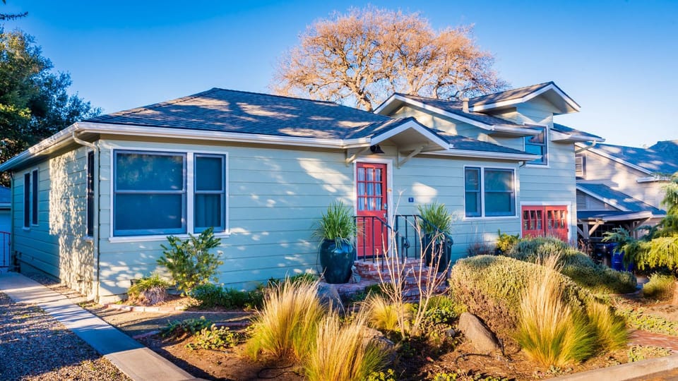 A charming exterior, mature landscaping, and a welcoming entry set the tone for a relaxing getaway.