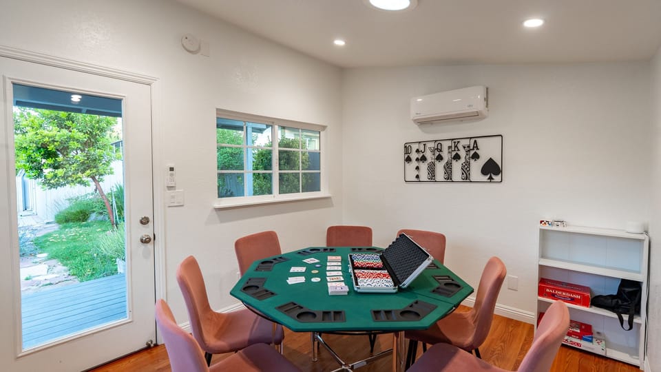 Compact game room with a poker table and yard access