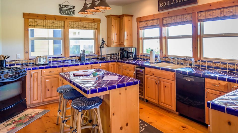 Welcoming kitchen with terracotta counters, generous cabinetry, and a central island.