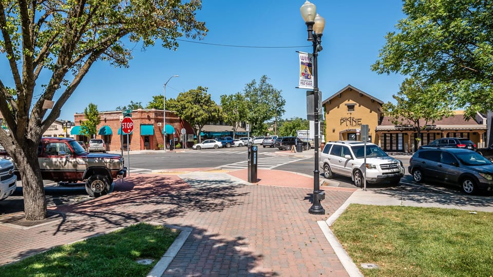Brick sidewalks and tree shade create an easygoing streetscape