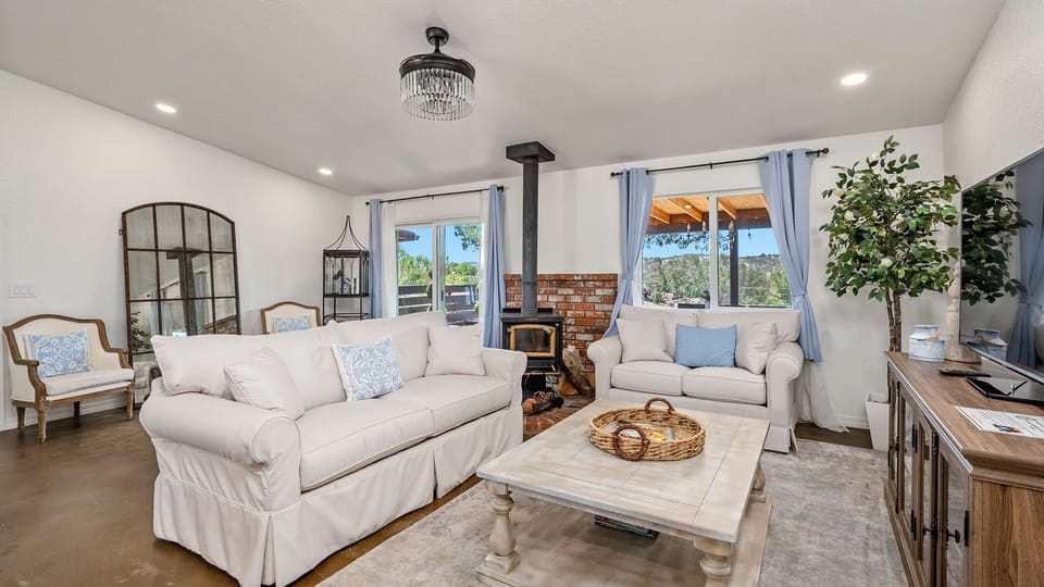 Bright living room with a brick hearth and wood stove