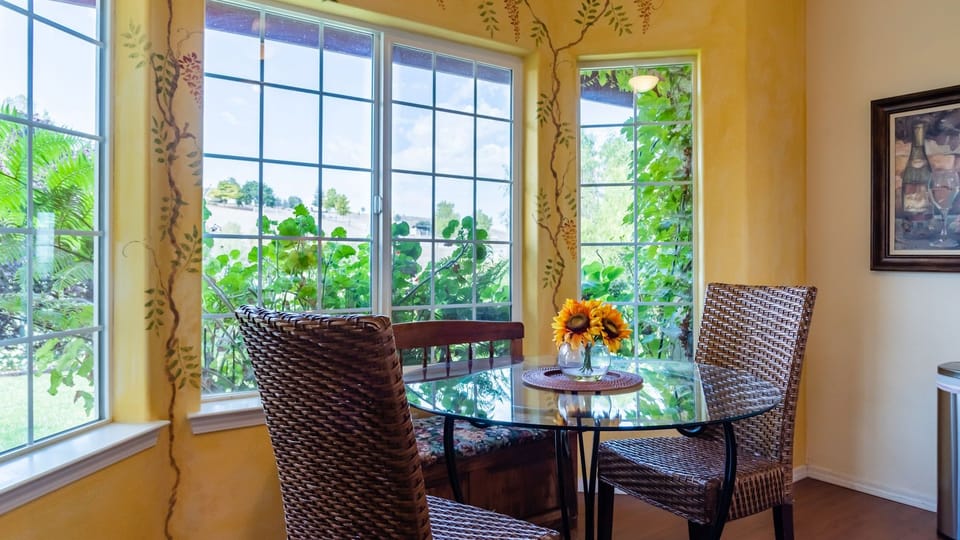 Gather around the glass table beside the garden view