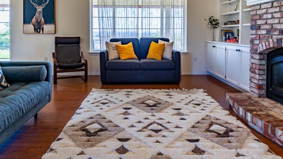 Blue seating and a front window keep the room bright.