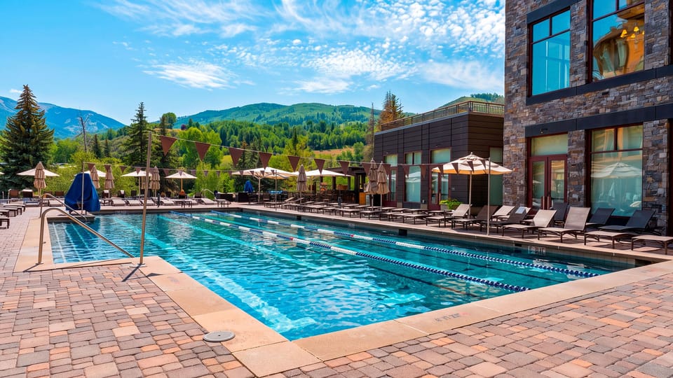 Spend sunny days by the resort-style outdoor pool, surrounded by loungers and sweeping mountain scenery.