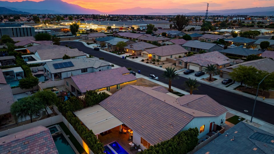 Overview of the property, surrounding neighborhood, and distant mountain vistas.